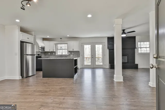 a view of a hallway with wooden floor