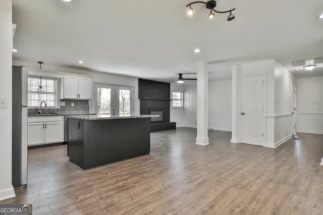 a kitchen with stainless steel appliances granite countertop a stove a sink and a refrigerator