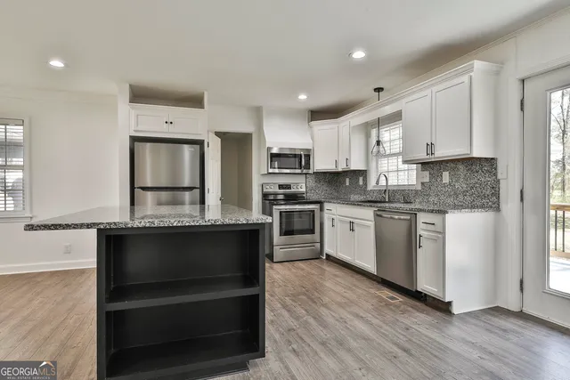 a kitchen with sink cabinets and stainless steel appliances