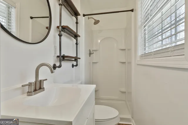 a living room with wooden floor and a fireplace