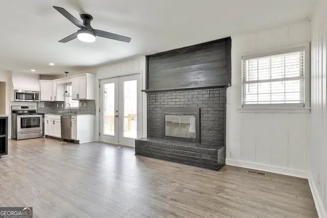 a view of a kitchen with wooden floor and a kitchen