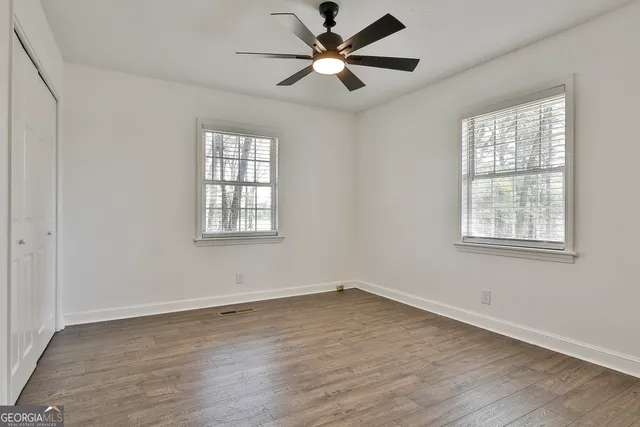 a bathroom with a granite countertop sink a mirror and a shower
