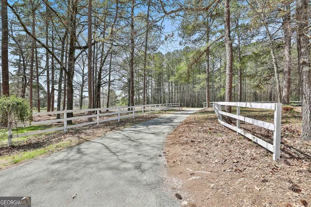 a view of a yard with wooden fence