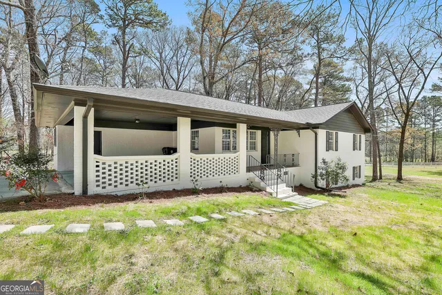 a view of a house with a yard and garage