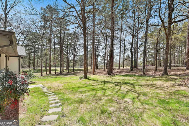 a backyard of apartments with large trees