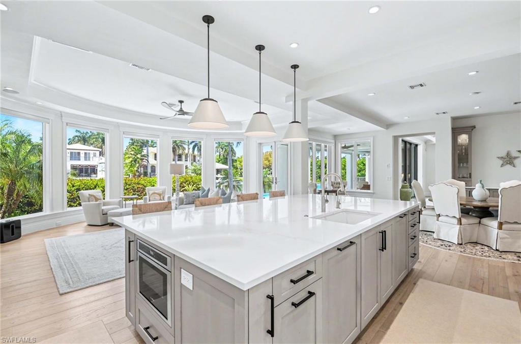 1888 6th Street South Naples, FL 34102 - Photo 10 of 37 a large white kitchen with a large window