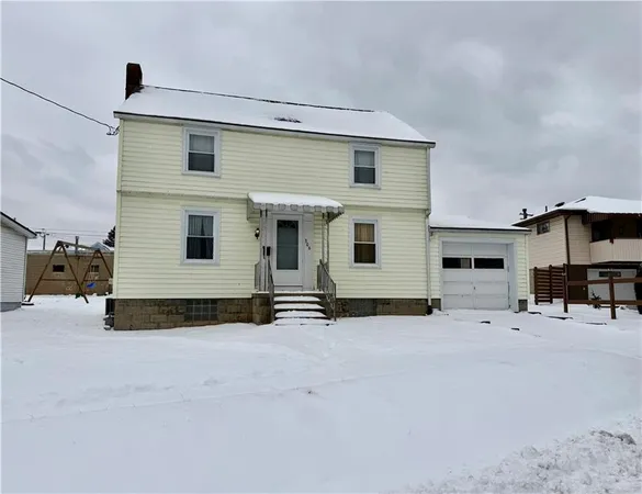 a view of a house with a yard and garage