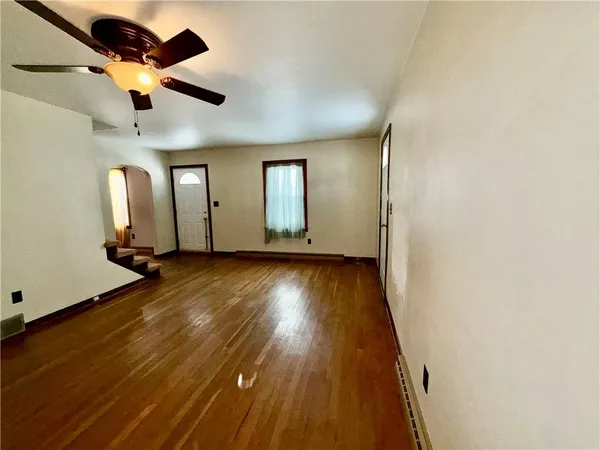 wooden floor in an empty room with a window
