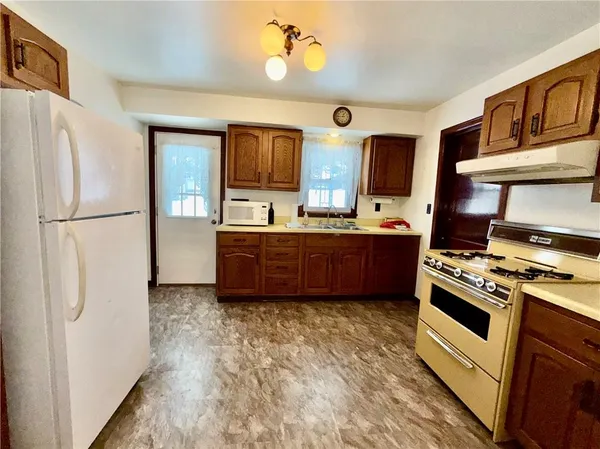 a kitchen with stainless steel appliances a stove a refrigerator and a sink