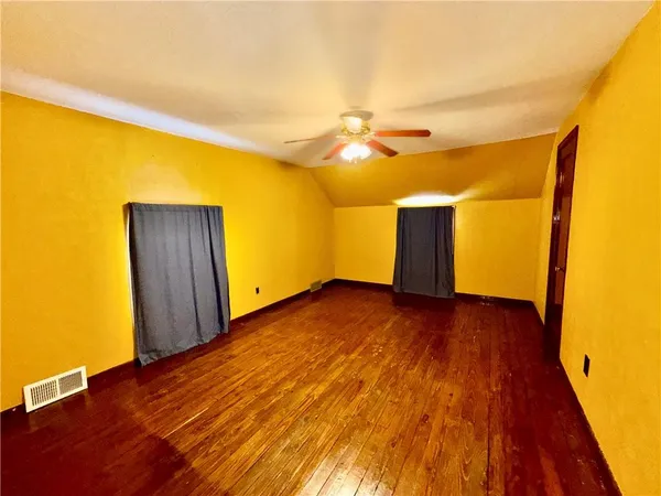 a view of a room with wooden floor