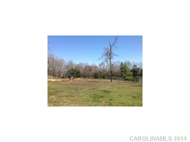 3615 Austin Road Monroe, NC 28112 - Photo 1 of 10 a picture of a bench in middle of the green field