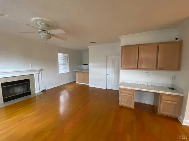 a view of empty room with a fireplace and cabinet