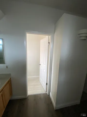 an empty room with wooden floor and a window