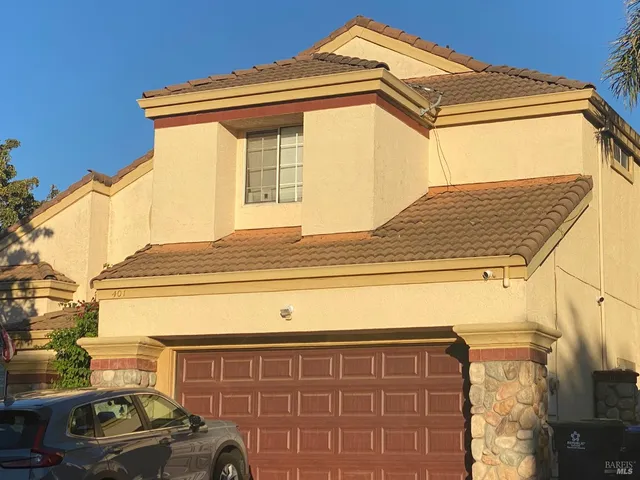 a view of a car parked front of a house