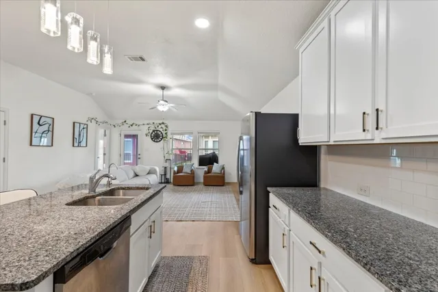 a living room with granite countertop kitchen island furniture and a kitchen view