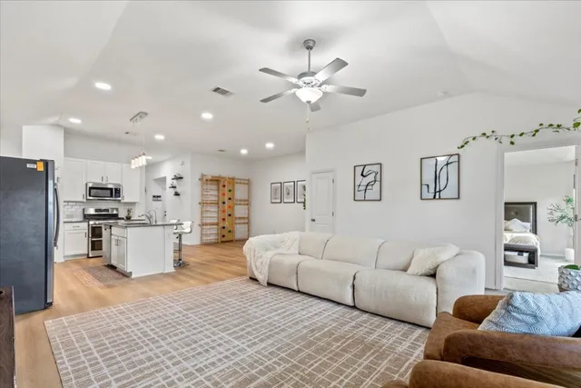 a living room with kitchen island furniture and a kitchen view