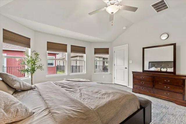 a bedroom with a large bed and a window