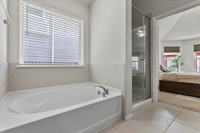 a spacious bathroom with a bathtub and a shower