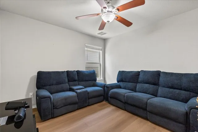 a living room with furniture a couch and a chandelier