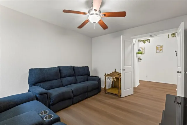 a living room with furniture and a chandelier