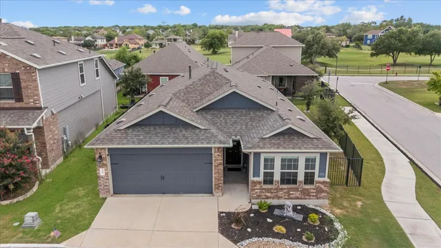 an aerial view of a house with a yard