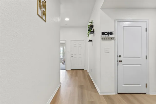 a view of a room with wooden floor