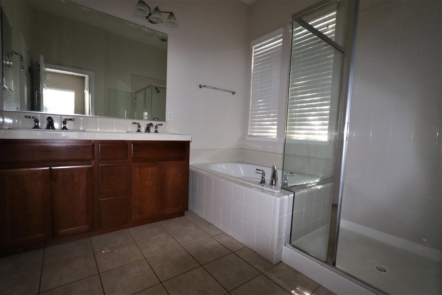 1709 Thomas Court Modesto, CA 95355 - Photo 11 of 11 a bathroom with a sink a vanity and mirror