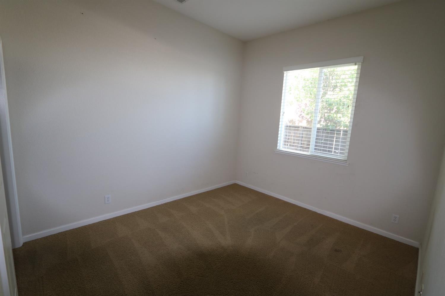 1709 Thomas Court Modesto, CA 95355 - Photo 5 of 11 an empty room with a window