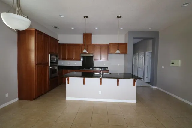 a view of kitchen with stainless steel appliances kitchen island microwave and cabinets