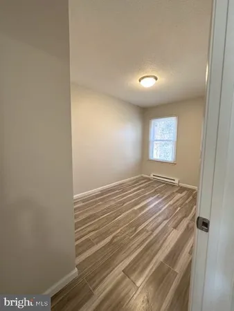 a view of a room with wooden floor