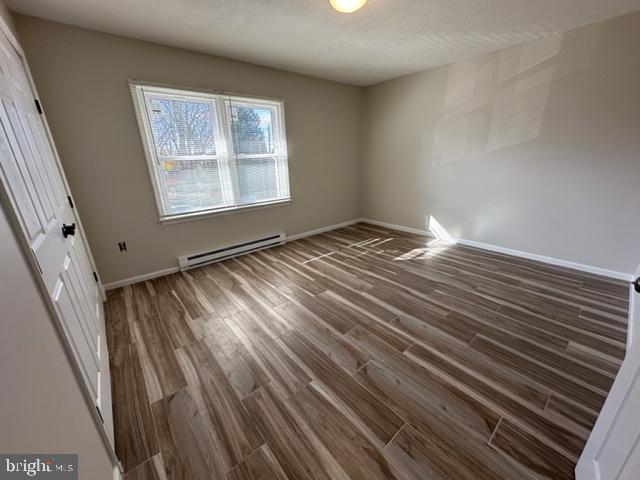 107 North Church Street Charles Town, WV 25414 - Photo 21 of 26 a view of an empty room with wooden floor and a window