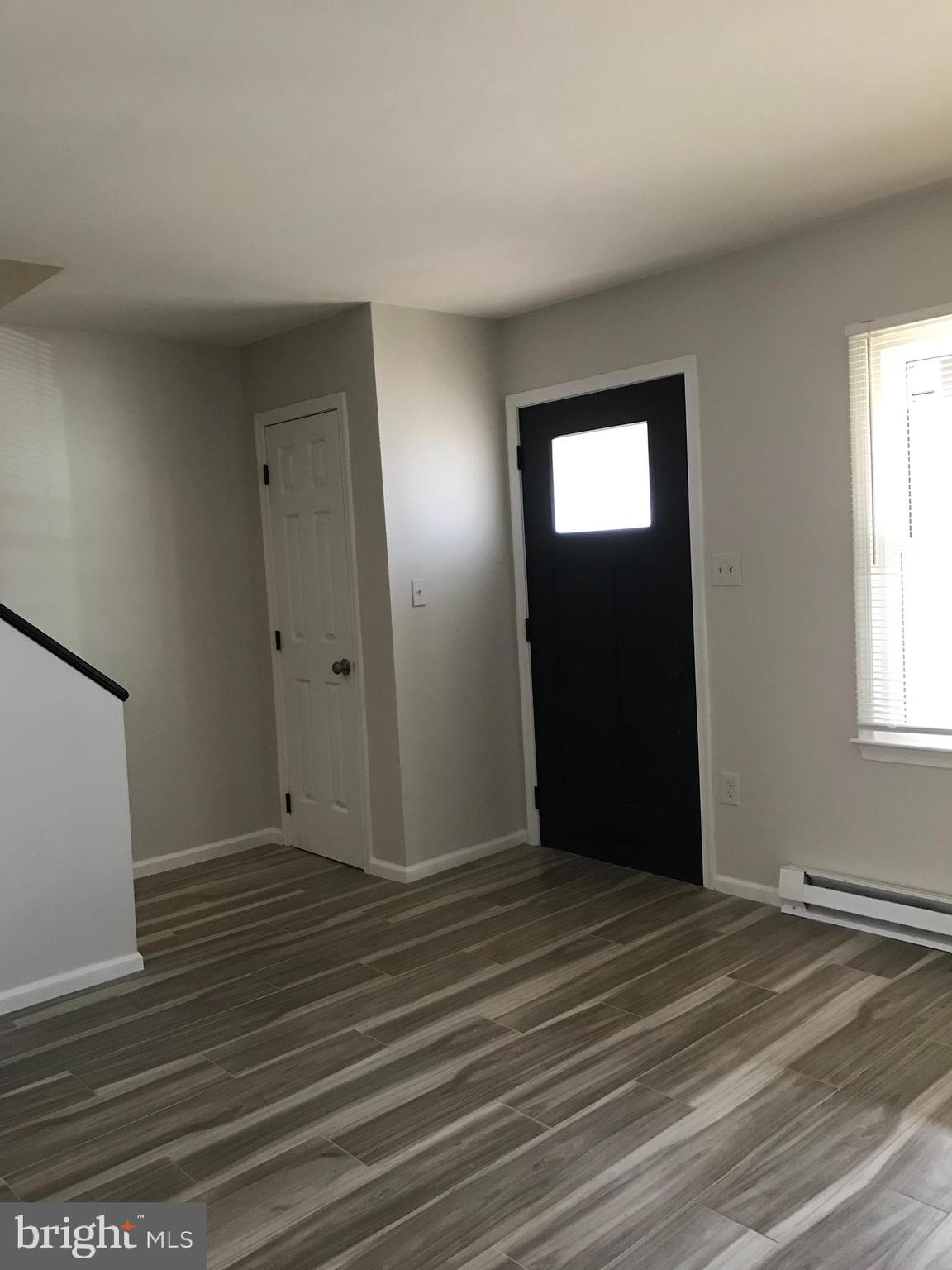 107 North Church Street Charles Town, WV 25414 - Photo 25 of 26 a view of an empty room with wooden floor and a window