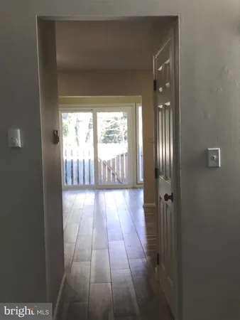 a view of hallway with wooden floor