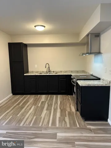 a view of kitchen with cabinets and wooden floor