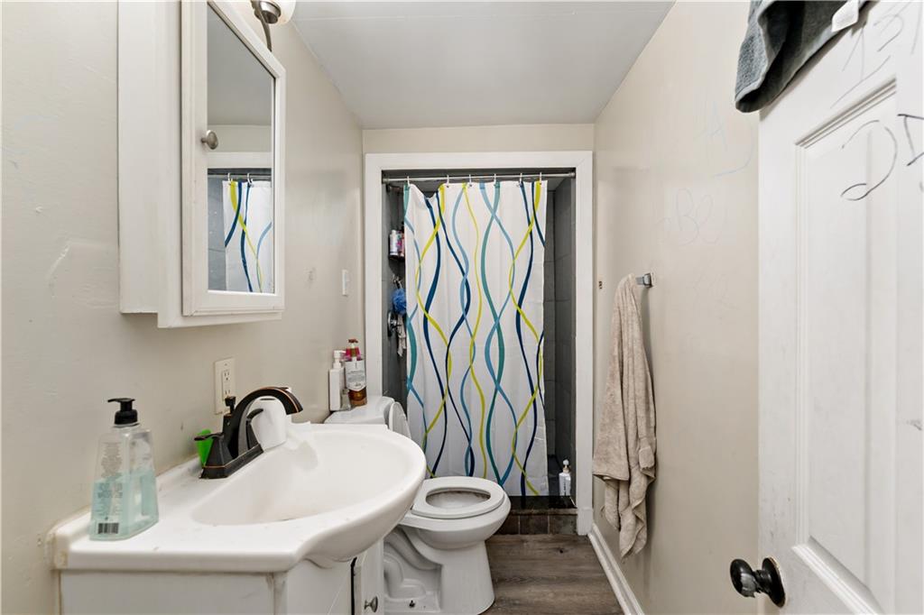 301 1st Avenue Carnegie, PA 15106 - Photo 23 of 40 a bathroom with a sink a toilet and a mirror