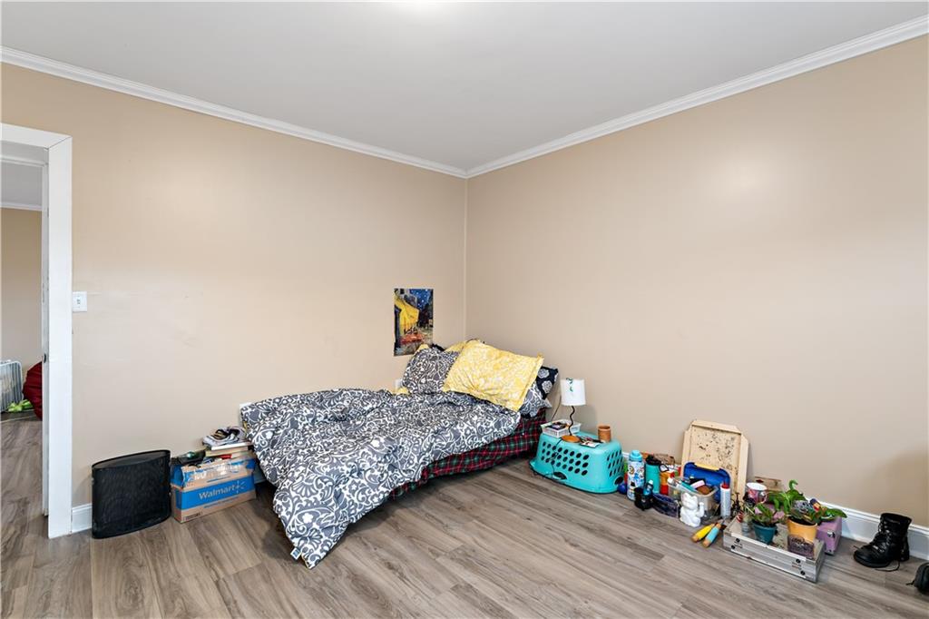 301 1st Avenue Carnegie, PA 15106 - Photo 26 of 40 a bedroom with a bed and wooden floor