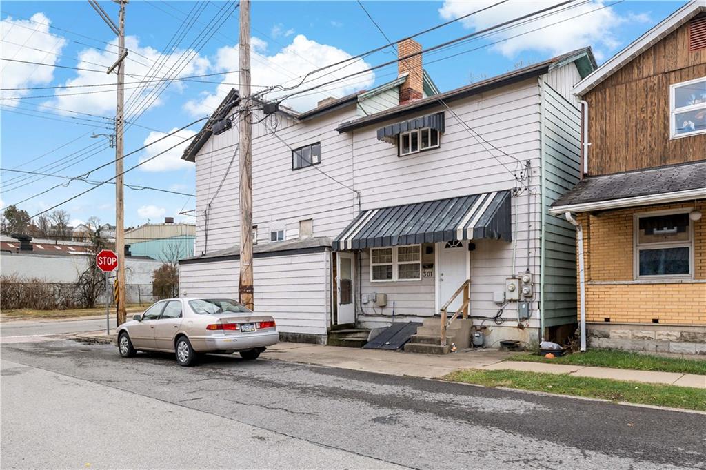 301 1st Avenue Carnegie, PA 15106 - Photo 33 of 40 a white car parked in front of a white house