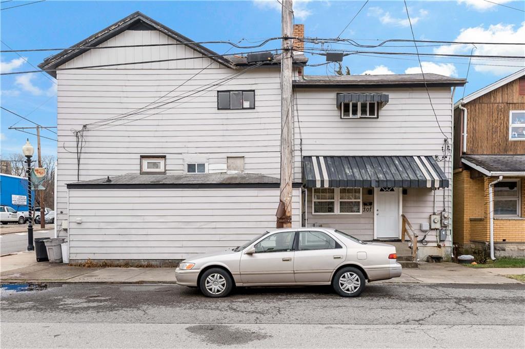 301 1st Avenue Carnegie, PA 15106 - Photo 34 of 40 a white car parked in front of a house