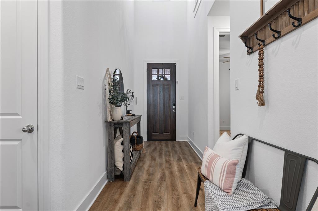 1332 Thompson Road Argyle, TX 76226 - Photo 5 of 36 Mudroom featuring wood finished floors and a high ceiling