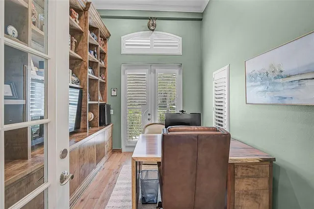 a bedroom with a bed a dresser and a window