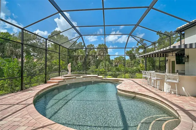 a view of a white house with a big yard and potted plants