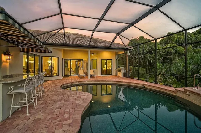 a dining room with furniture a rug and a chandelier
