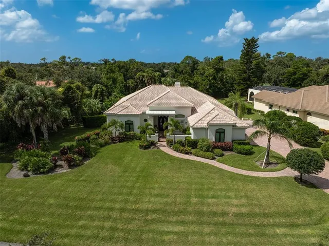 a view of a house with swimming pool and a yard