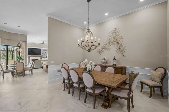 a kitchen with kitchen island granite countertop a stove top oven a sink dishwasher a dining table and chairs with wooden floor