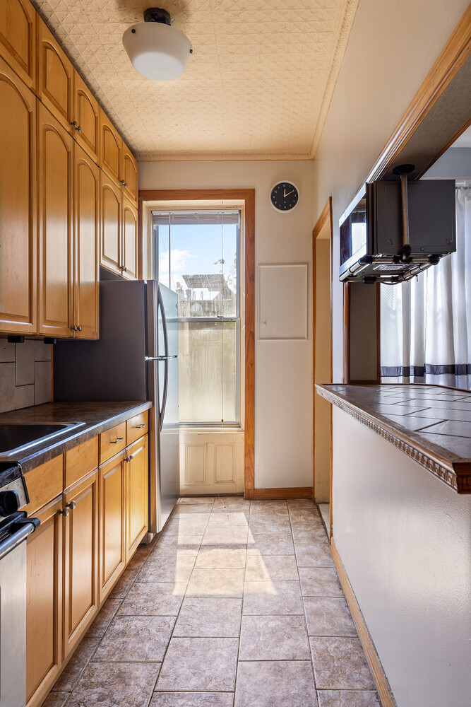 490 Monroe Street Brooklyn, NY 11221 - Photo 10 of 15 a kitchen with stainless steel appliances granite countertop a refrigerator and a sink