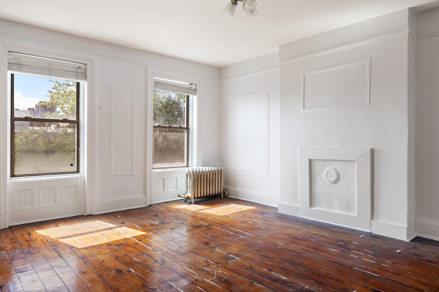 490 Monroe Street Brooklyn, NY 11221 - Photo 11 of 15 a view of an empty room with window and wooden floor