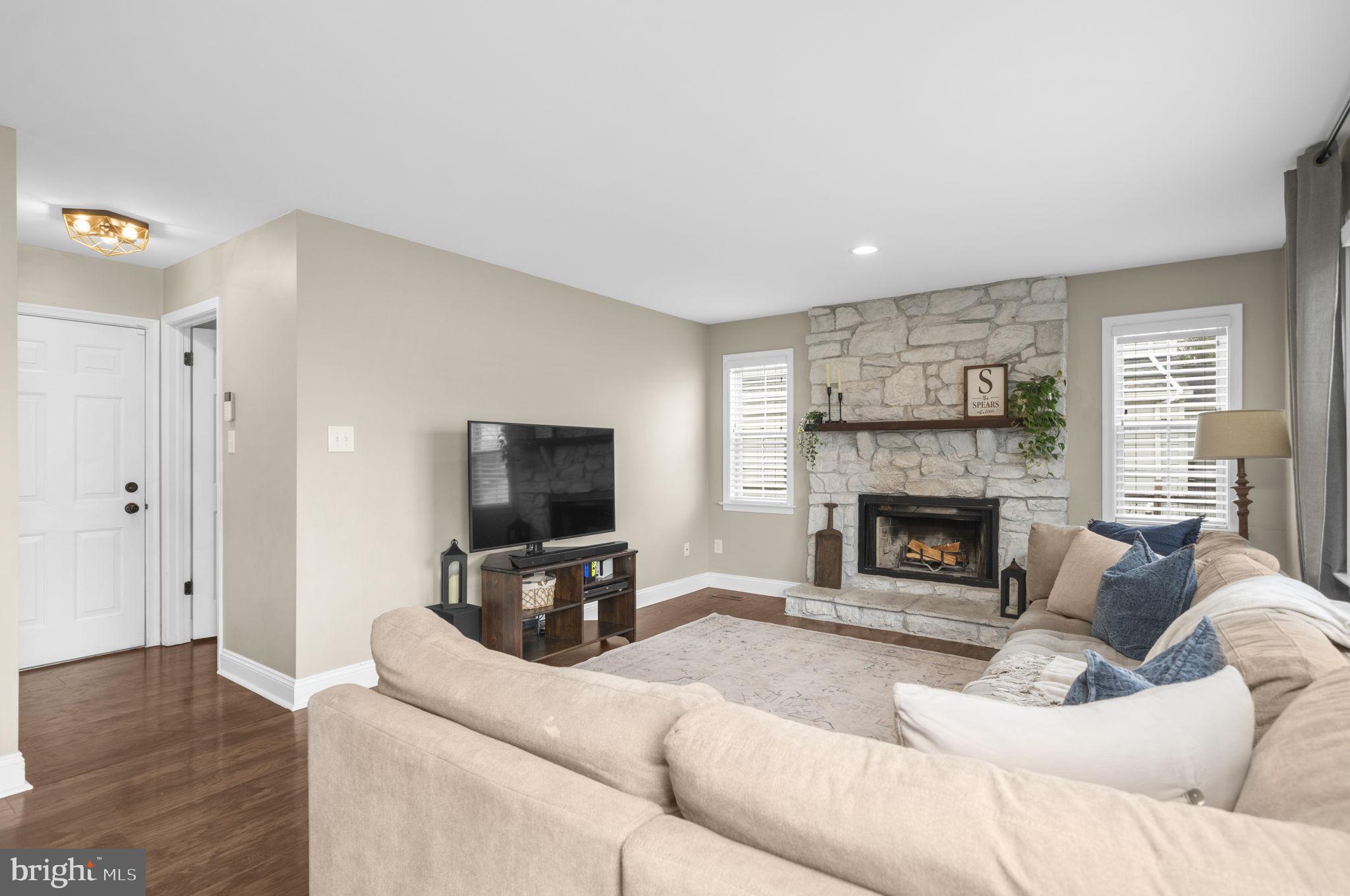 150 Nectar Run Telford, PA 18969 - Photo 14 of 41 a living room with furniture a fireplace and a flat screen tv