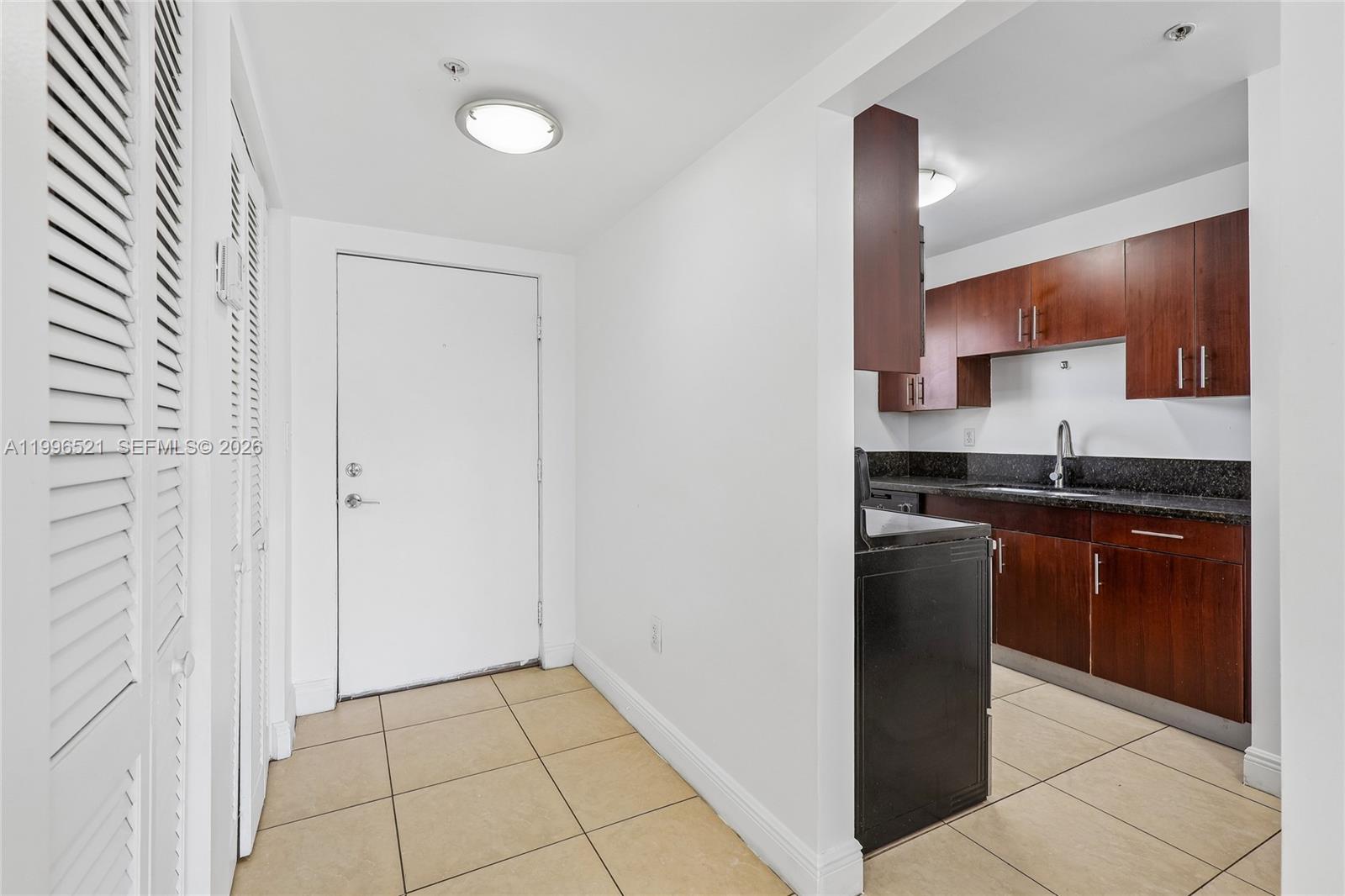 4137 Stirling Road, Unit 507 Dania Beach, FL 33314 - Photo 3 of 20 a kitchen with stainless steel appliances granite countertop a refrigerator and a sink