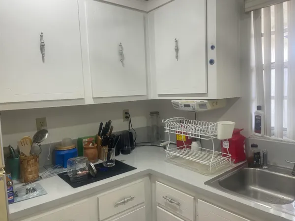 a kitchen with a sink and cabinets
