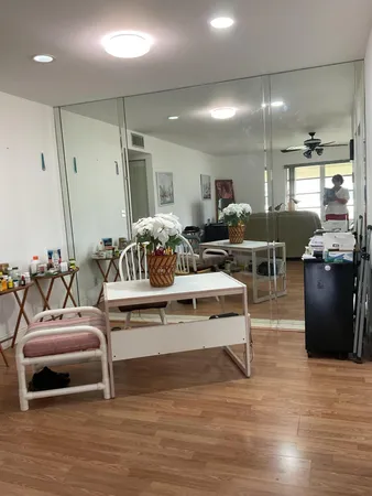 a living room with furniture flat screen tv and a wooden floor